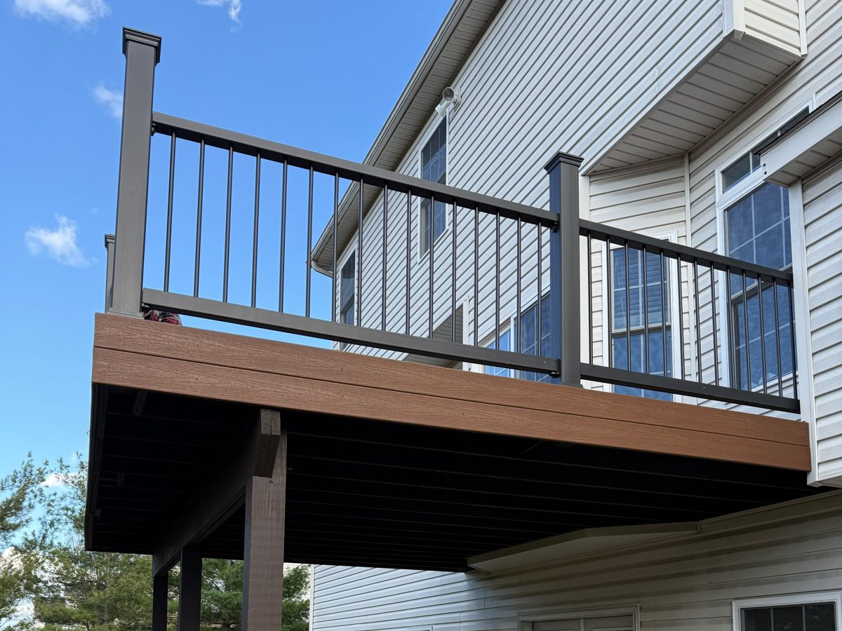 Second-story composite deck with dark posts and black aluminum balusters